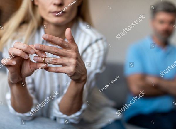 A couple in bed, turned away from each other